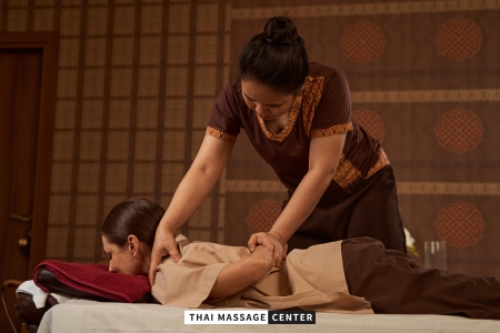 Professional Thai therapist performing assisted stretching during a traditional Thai massage in Nicosia