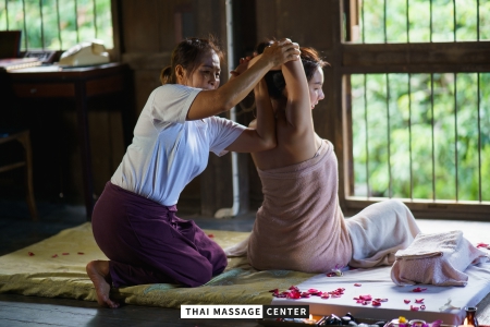 Thai therapist performing assisted stretching during a Traditional Thai Massage
